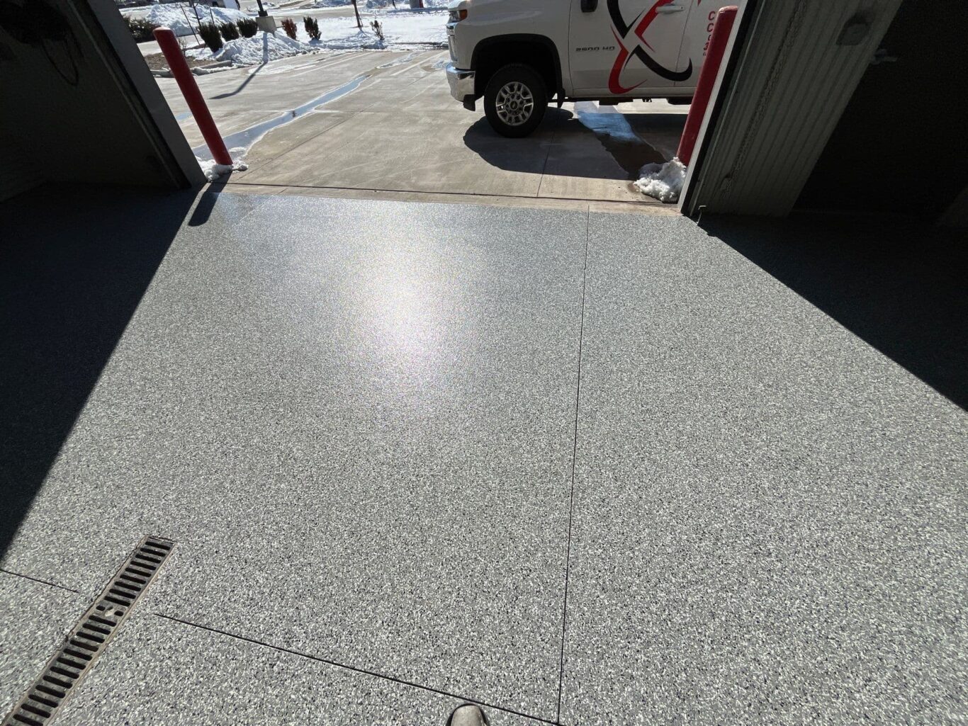 Glossy Domino flake floor leading from shop interior to driveway.