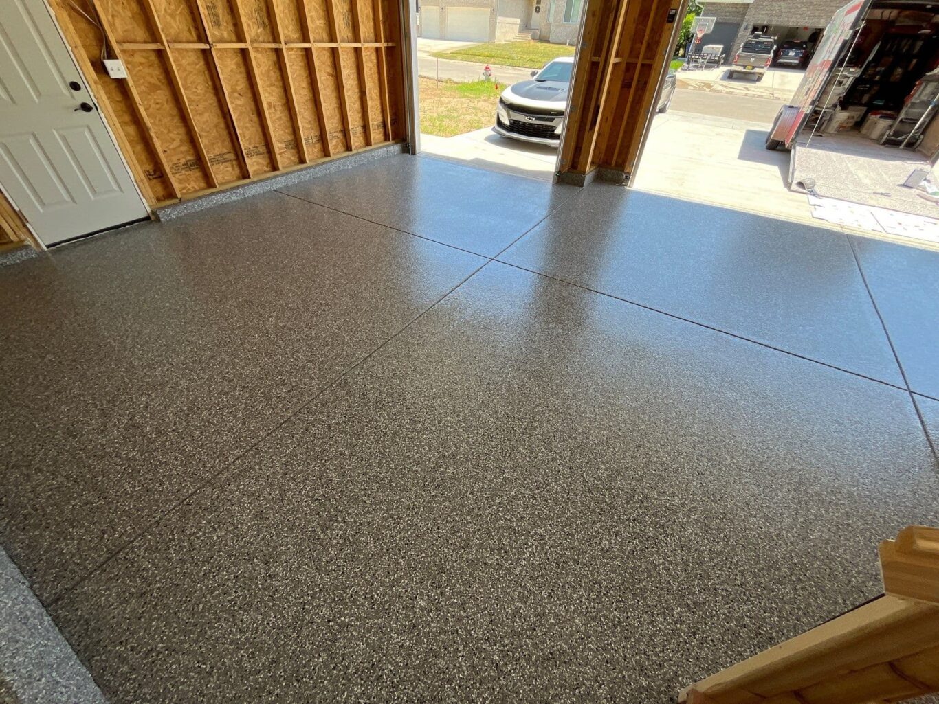 Newly coated garage floor in Andover, KS with Smoke flake blend and glossy finish.