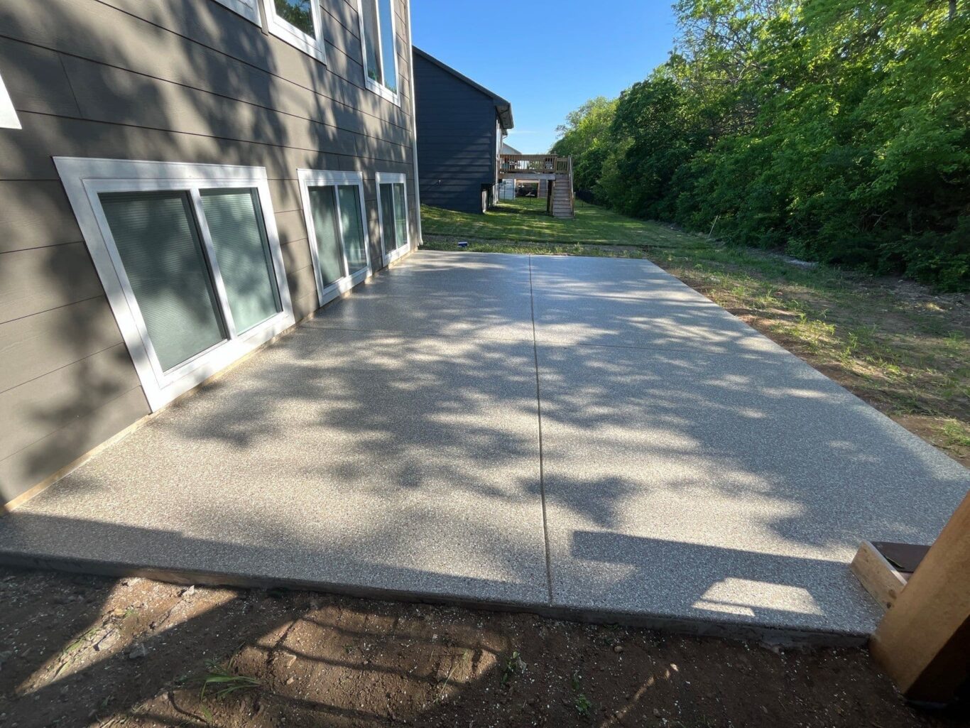Backyard patio coated with Penntek system, smooth surface designed for Kansas weather.