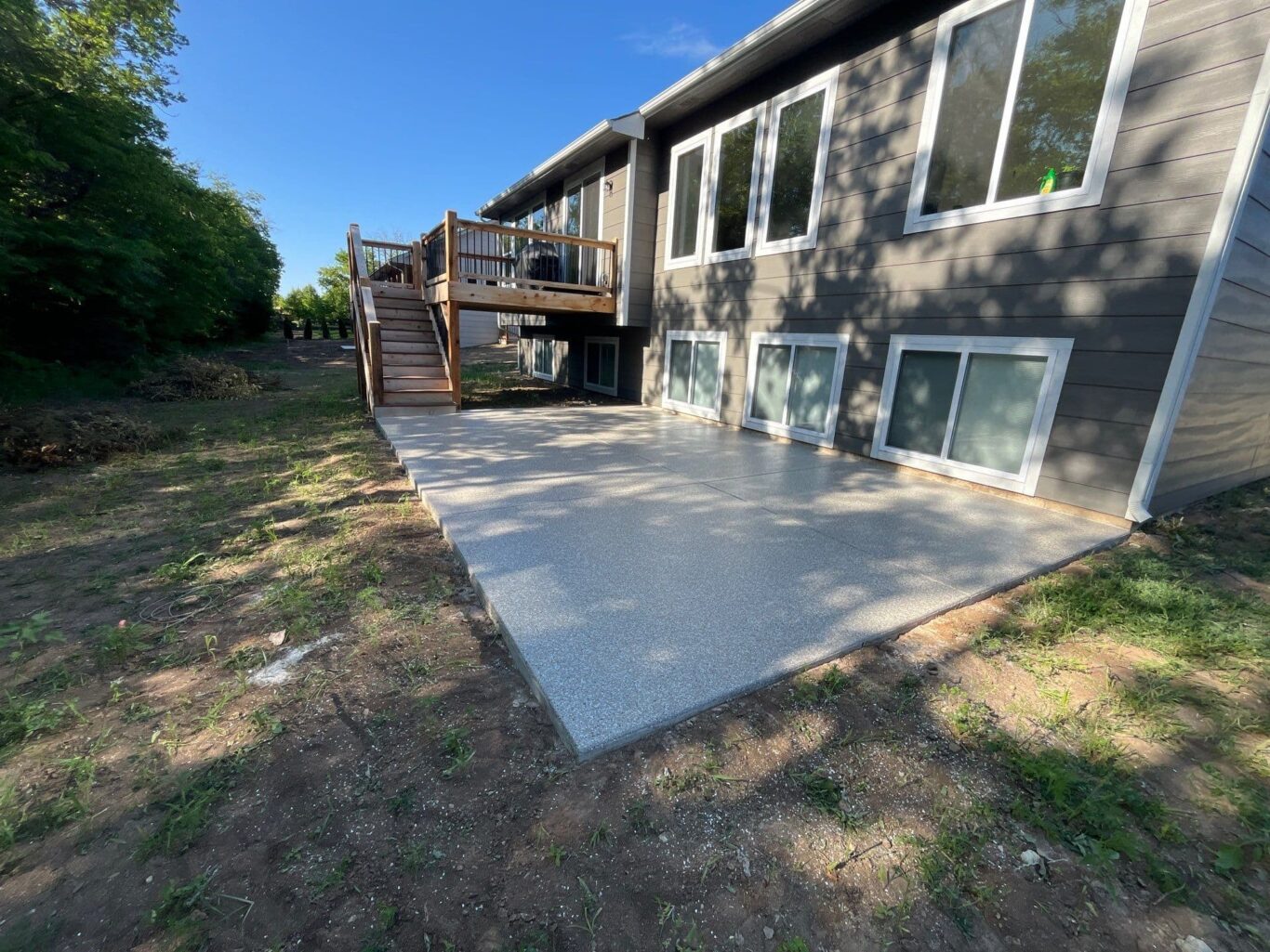 Finished patio floor coating in Andover, KS with light Smoke flake blend for outdoor durability.